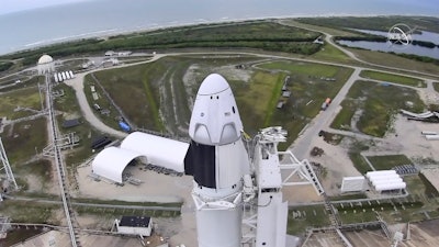 In this image made from video via NASA-TV, a SpaceX Falcon 9, with NASA astronauts Doug Hurley and Bob Behnken in the Dragon crew capsule, prepare to lift off from Pad 39-A at the Kennedy Space Center in Cape Canaveral, Fla., May 27, 2020.