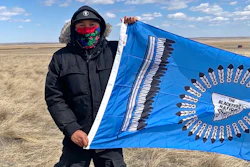 This photo from early May, 2020, provided by Angeline Cheek shows Curtis Yazzie as he demonstrates at a construction site for the XL Pipeline just inside the U.S.-Canadian border near Saco, Mont. Members of several tribes in Montana and North Dakota traveled to the border crossing for a small protest against the pipeline earlier this month, according to Cheek, an activist from Montana's Fort Peck Tribe and organizer for the ACLU of Montana. Calgary-based TC Energy has built the first piece of the disputed Keystone XL oil sands pipeline across the U.S. border and started work on labor camps in Montana and South Dakota.