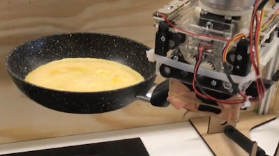 Robot arm preparing an omelette.