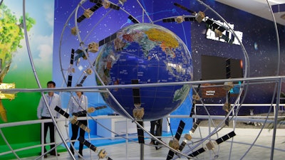 A model of the Beidou Navigation Satellite System displayed during Airshow China in Zhuhai, Nov. 6, 2018. , China has delayed the launch of the final satellite to complete its Beidou Navigation Satellite System constellation that emulates the U.S. Global Positioning System. The official Xinhua News Agency said Tuesday, June 16, 2020’s mission aboard a Long March-3 rocket from the southwestern satellite launch base of Xicheng was scrubbed after pre-launch checks discovered “product technical problems.” (AP Photo/Kin Cheung, File)
