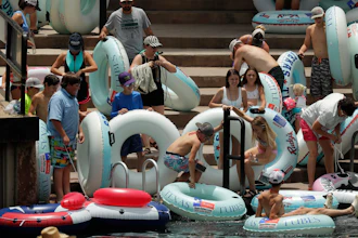 Tubers prepare to float the Comal River, despite the recent spike in COVID-19 cases, June 25, 2020, in New Braunfels, Texas.