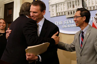 California state Sen. Bob Hertzberg, D-Van Nuys, left, and Assemblyman Ed Chau, D-Arcadia, right, celebrate with Alastair Mactaggart, center, after the Legislature approved their data privacy bill in Sacramento, June 28, 2018.