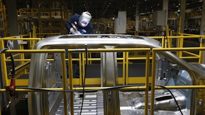 Ron Hudgins welds a Ford F-150 cab at the Dearborn Truck Plant in Dearborn, Mich., Nov. 11, 2014.