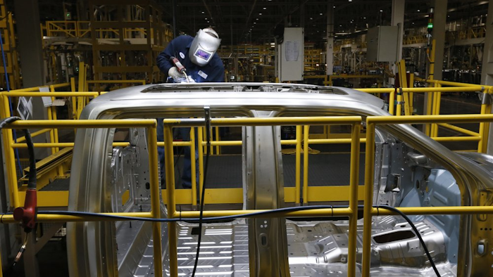 Ron Hudgins welds a Ford F-150 cab at the Dearborn Truck Plant in Dearborn, Mich., Nov. 11, 2014.