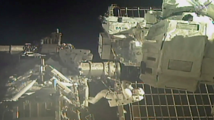 In this image taken from video, commander Chris Cassidy, right, and astronaut Bob Behnken perform a spacewalk, July 1, 2020.