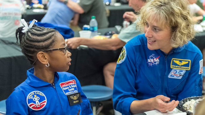 NASA astronaut Dottie Metcalf-Lindenburger talks with Space Camp camper Bria Jackson of Atlanta before giving a speech at the U.S. Space & Rocket Center in Huntsville, Ala., July 13, 2018.