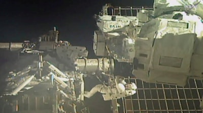 In this image taken from video, commander Chris Cassidy, right, and astronaut Bob Behnken perform a spacewalk, July 1, 2020.