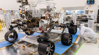 Engineers watch the first driving test for the Mars 2020 rover Perseverance in a clean room at the Jet Propulsion Laboratory in Pasadena, Calif., Dec. 17, 2019.