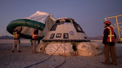 In this Sunday, Dec. 22, 2019 photo made available by NASA, Boeing, NASA, and U.S. Army personnel work around the Boeing Starliner spacecraft shortly after it landed in White Sands, N.M. On Tuesday, July 7, 2020, NASA officials said they have identified 80 corrective actions for safety, mostly involving software, that must be implemented before the Starliner capsule launches again. The previous count was 61.