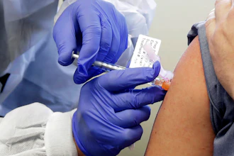 A subject receives a shot in the first-stage safety study clinical trial of a potential vaccine by Moderna for COVID-19 at the Kaiser Permanente Washington Health Research Institute in Seattle, March 16, 2020.