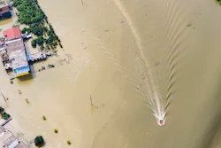 In this aerial photo released by Xinhua News Agency, rescue workers on a raft are seen moving through flood waters to help evacuate trapped residents in Sanjiao Township of Yongxiu County in central eastern China's Jiangxi Province on Monday, July 13.