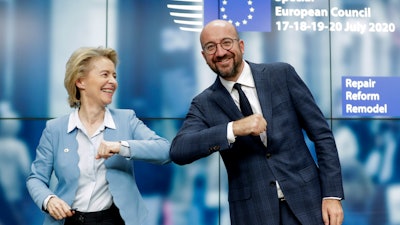 European Commission President Ursula von der Leyen, left, and European Council President Charles Michel bump elbows after addressing a media conference at an EU summit in Brussels, July 21, 2020.