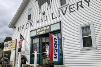 A man wearing a mask leaves a gift shop in Hope Valley, R.I., July 15, 2020.