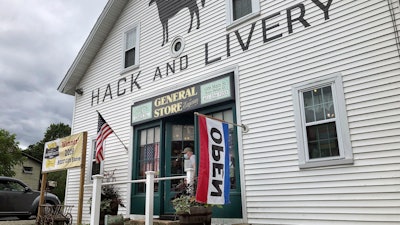 A man wearing a mask leaves a gift shop in Hope Valley, R.I., July 15, 2020.