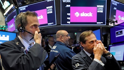 Traders Gregory Rowe, left, and Dudley Devine, right, on the floor of the New York Stock Exchange, June 20, 2019.