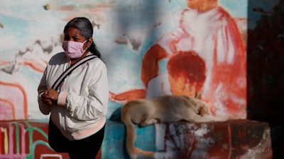 A woman waits to get tested for COVID-19 at a mobile diagnostic tent in San Gregorio Atlapulco, Xochimilco, Mexico City, July 22, 2020.