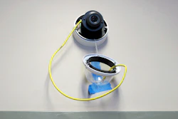 A camera with facial recognition capabilities hangs from a wall during installation at Lockport High School in Lockport, N.Y., July 10, 2018.