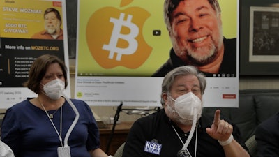 Apple co-founder Steve Wozniak, right, gestures beside his wife Janet Hill during a media conference, July 23, 2020, in Burlingame, Calif.