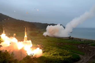 South Korea's Hyunmoo II Missile system, left, and a U.S. Army Tactical Missile System fire missiles during a combined military exercise, July 29, 2017.