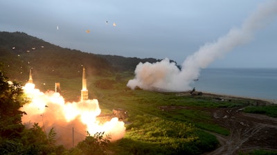 South Korea's Hyunmoo II Missile system, left, and a U.S. Army Tactical Missile System fire missiles during a combined military exercise, July 29, 2017.