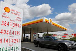 A car leaves a Shell station.