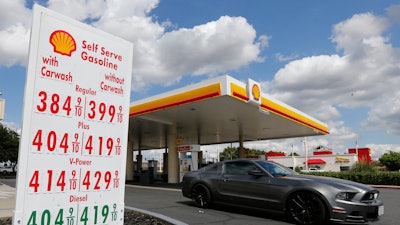 A car leaves a Shell station.