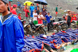 People gather near the bodies of victims of a landslide near a jade mining area in Hpakant, Kachin state, northern Myanmar Thursday, July 2, 2020. Myanmar government says a landslide at a jade mine has killed dozens of people.