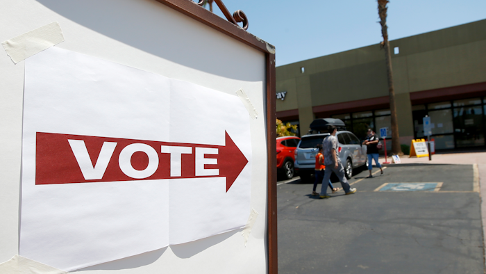 Voters walk to a polling station to cast votes in Arizona's primary, Aug. 4, 2020, Chandler, Ariz.