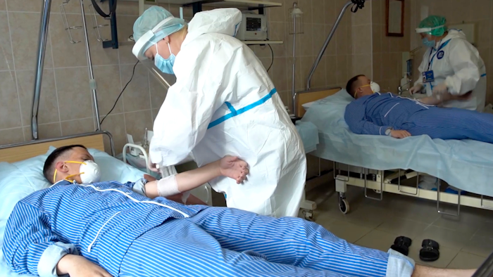 Medical workers prepare to draw blood from volunteers participating in a trial of a coronavirus vaccine at the Budenko Main Military Hospital outside Moscow, July 15, 2020.