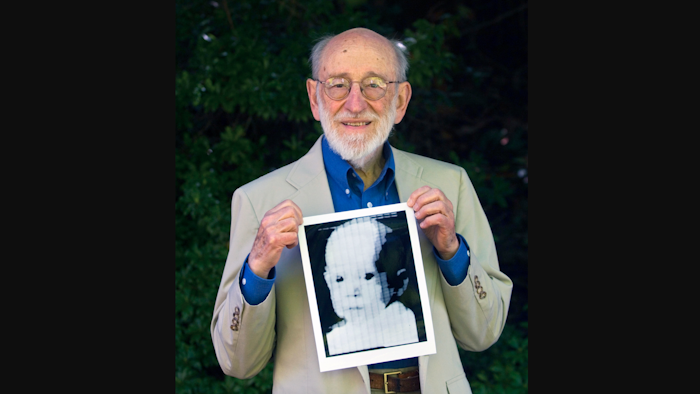 In this 2007 file photo, Russell Kirsch holds the image of his son, Walden, that was scanned into the world's first digital scanner in 1957.