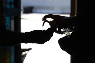 Hand sanitizer is squirted into a worshiper's hands as they enter for a Sunday Mass at a church in Paterson, N.J., June 14, 2020.