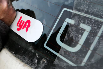 A Lyft logo is installed next to an Uber sticker in Pittsburgh, Jan. 31, 2018.