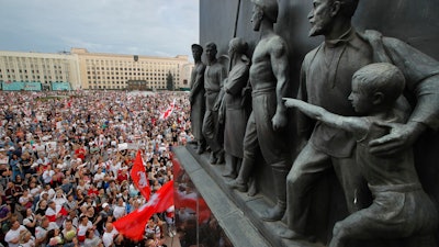 Protest rally in Minsk, Belarus, with Soviet-era sculptures in the foreground, Aug. 18, 2020.
