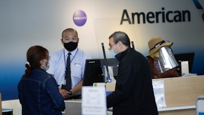 Travelers check in at the American Airlines terminal, Los Angeles International Airport, May 28, 2020.