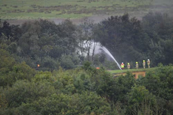 Emergency services at the scene after a fire on a freight train carrying diesel fuel near Llanelli, Wales, Aug. 27, 2020.