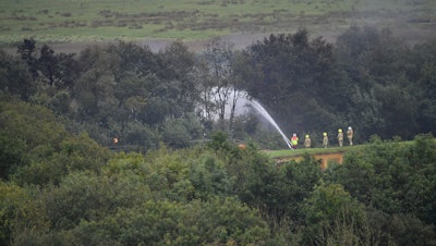 Emergency services at the scene after a fire on a freight train carrying diesel fuel near Llanelli, Wales, Aug. 27, 2020.