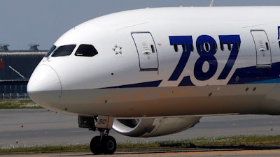 A Boeing 787 lands after a test flight at Haneda International Airport in Tokyo, April 28, 2013.