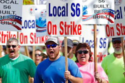 In this July 25, 2020 file photo, striking Bath Iron Works shipbuilders march in solidarity in Bath, Maine. A 63-day strike at Bath Iron Works — against the backdrop of a pandemic in an election year — came to an end Sunday, Aug. 23 with shipbuilders voting to return to their jobs producing warships for the United States Navy.