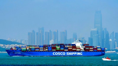 A China COSCO Shipping container ship sails past the skyline of Qingdao in eastern China's Shandong Province, on July 28, 2020. China's exports rose 7.2% in July over a year earlier despite the coronavirus pandemic. Sales to the United States rose 12.5% despite lackluster U.S. economic activity and lingering tariff war with Washington.