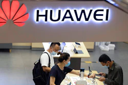 In this July 15, 2020 file photo, visitors wearing masks to curb the spread of the coronavirus look at the latest products at a Huawei store in Beijing. The U.S. government is imposing another round of restrictions on tech giant Huawei as President Donald Trump renews accusations the Chinese company’s telecommunications equipment is used for spying. The Commerce Department’s new rules which will further block Huawei from getting access to chip technology.