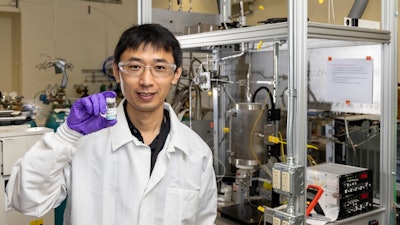 Zhenglong Li, an ORNL scientist in the Energy and Transportation Science Division, holds a sample of a catalyst material used to covert ethanol into butene-rich mixed olefins.