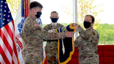 Lt. Gen. Stephen G. Fogarty, commander of U.S. Army Cyber Command (left) and ARCYBER senior enlisted leader Command Sgt. Maj. Sheryl D. Lyon (right) unfurl the ARCYBER colors in the command's new headquarters at Fort Gordon, Ga., July 24, 2020.