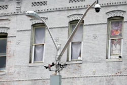 A surveillance camera, top right, and license plate scanners, center, at an intersection in West Baltimore, April 29, 2020.