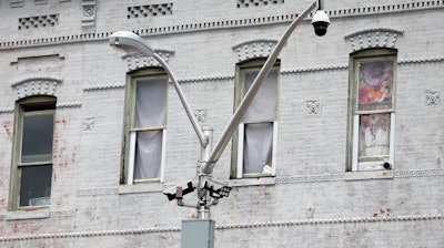A surveillance camera, top right, and license plate scanners, center, at an intersection in West Baltimore, April 29, 2020.