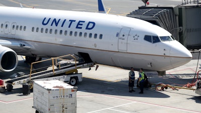 A United Airlines commercial jet sits at a gate at Terminal C of Newark Liberty International Airport, Newark, N.J., July 18, 2018.