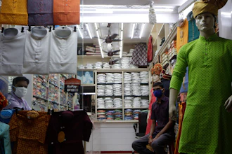 A shopkeeper and his staff wait for customers at a garment store in Mumbai, Aug. 31, 2020.