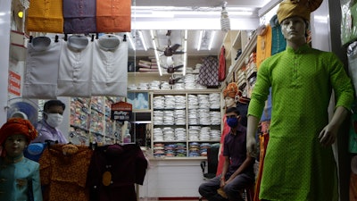 A shopkeeper and his staff wait for customers at a garment store in Mumbai, Aug. 31, 2020.