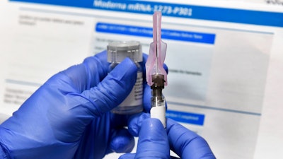 A nurse prepares a shot during a study of a possible COVID-19 vaccine developed by the National Institutes of Health and Moderna, Binghamton, N.Y., July 27, 2020.
