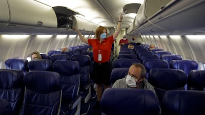 A Southwest Airlines flight attendant prepares for takeoff at Kansas City International Airport, Kansas City, Mo., May 24, 2020.