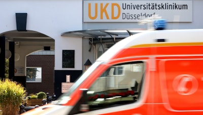 An ambulance drives past the University Hospital in Duesseldorf, Sept. 15, 2020.